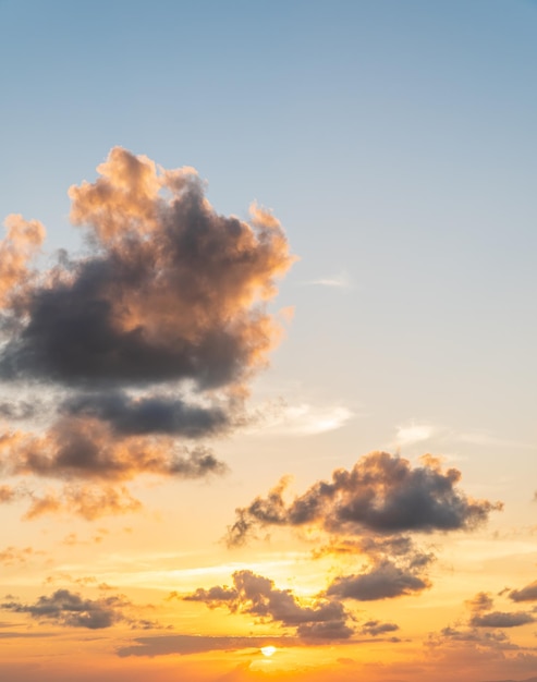 Sunset sky vertical in the evening with orange sunlight on golden hour