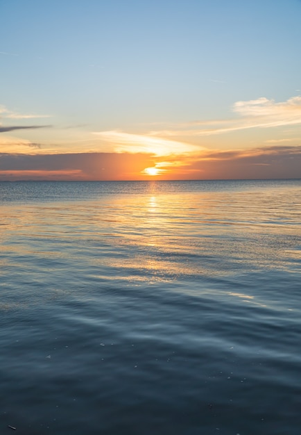 Sunset sky vertical over sea in the evening