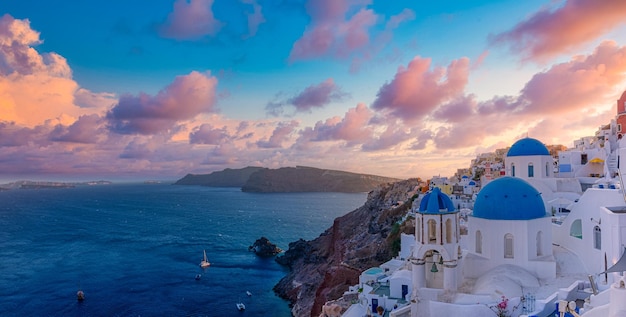 Sunset sky view of the blue dome churches of Santorini Greece Famous summer travel destination