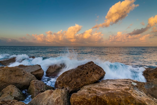 Sunset sky over the waves of the sea