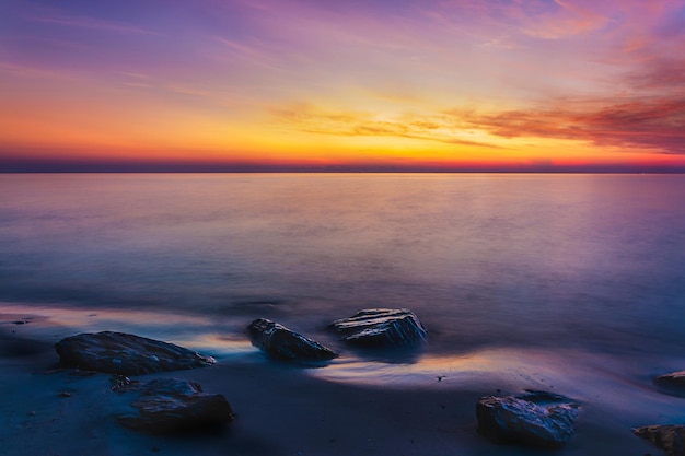 Sunset sky with dramatic sunset clouds over the sea Beautiful sunrise over Ocean