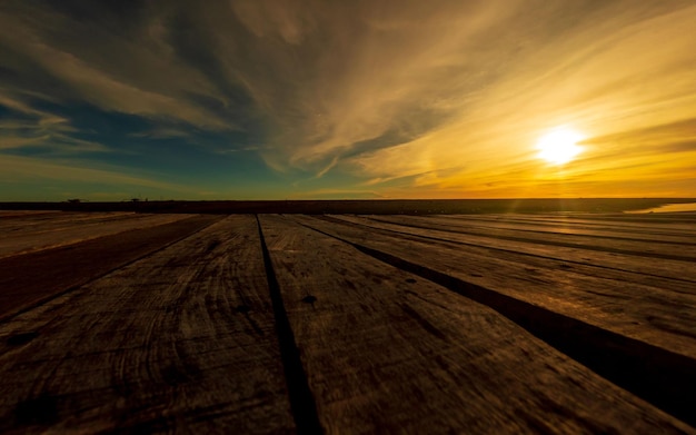 Sunset sky with wooden bridge in foreground