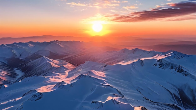 a sunset over a snowy mountain range