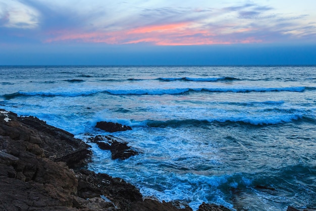 Sunset summer Atlantic Ocean rocky coast (Guincho, Portugal).