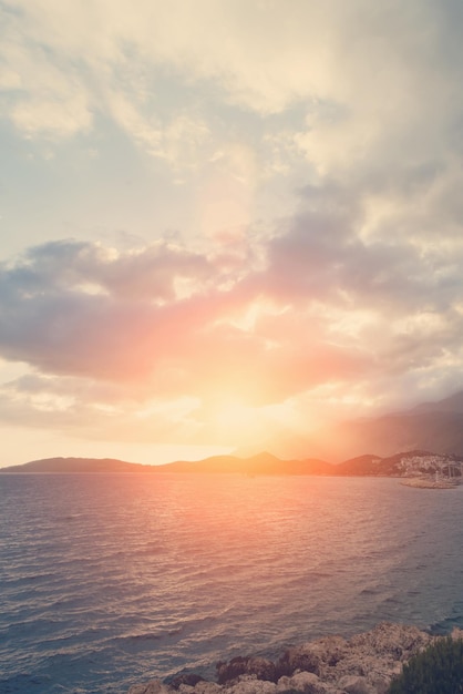 Sunset or sunrise over the rocky coast and sea