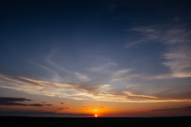 Sunset sunrise with clouds, light rays and other atmospheric 