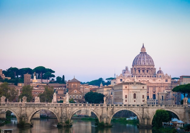 Sunset on Tiber river bridge with Vatican City Rome Italy