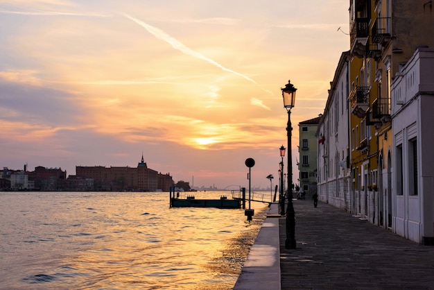 Sunset view to orange sky with bright sun shining in Venice