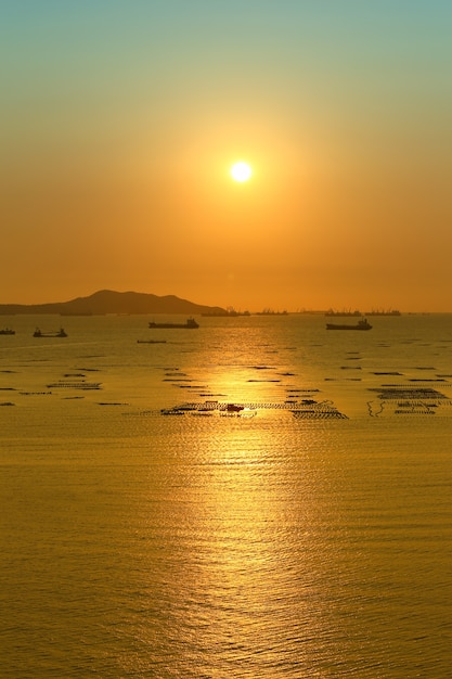 Sunset view overlooking Koh Sichang and cargo ship in sea