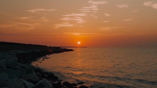 A sunset over the water with the sun setting behind it