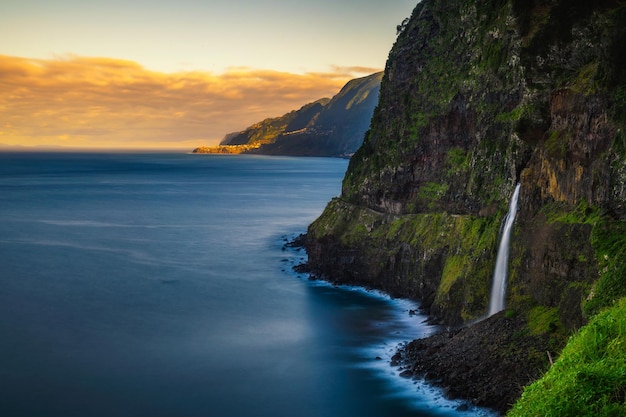 Sunset at a waterfall near seixal village in the madeira islands portugal