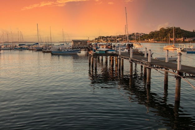 Sunset with sailboats anchored at the edge of the Ribeira in Salvador Bahia Brazil