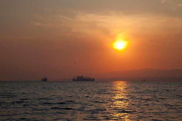 A sunset with a ship in the background