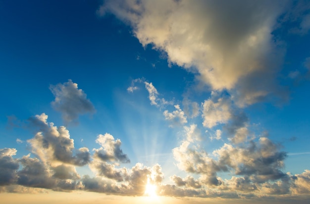 Sunset with sun rays sky with clouds and sun