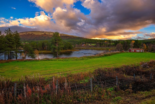 Sunset over a wooden cabin and Glomma River in Innlandet county Norway