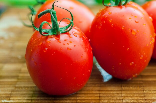 Sunshine fresh tomatoes wooden cutting board