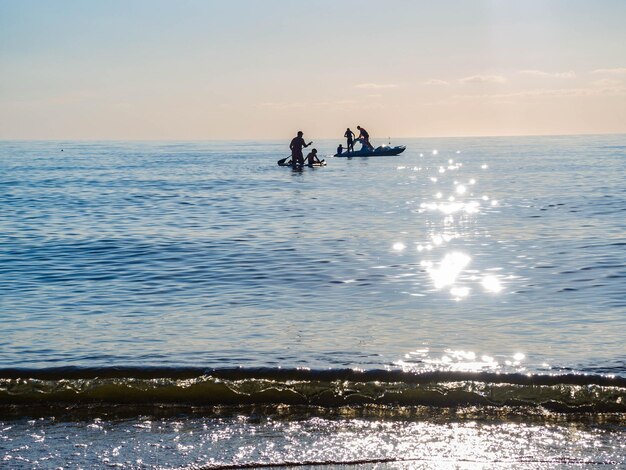 Sup surfing training swim in the open sea on SAP surfing catamaran