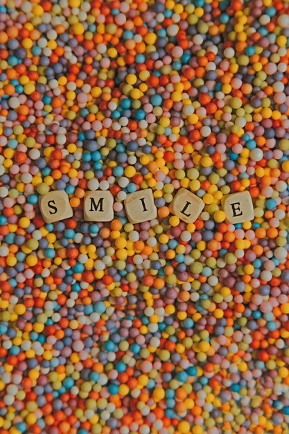 Photo super colorful mock up with happy and fun concept colorful balls with smile written in dices background stunning wonderful