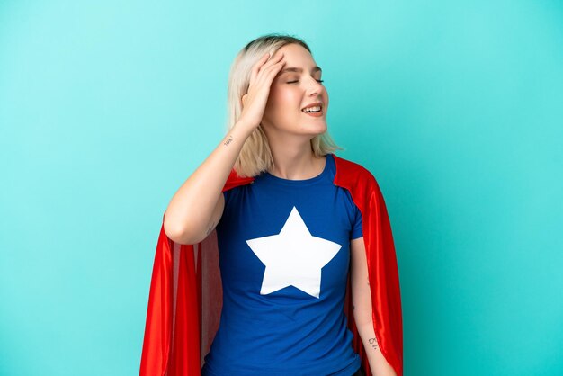 Super Hero caucasian woman isolated on blue background has realized something and intending the solution