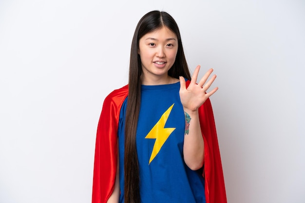 Super Hero Chinese woman isolated on white background counting five with fingers