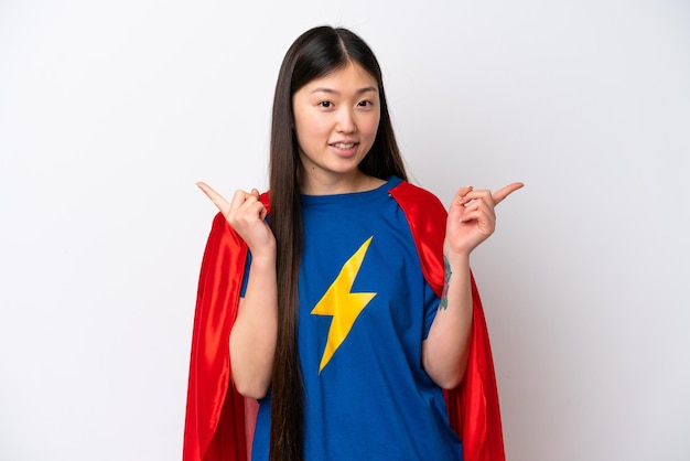 Super Hero Chinese woman isolated on white background pointing finger to the laterals and happy