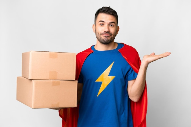 Super Hero delivery caucasian man over isolated white background having doubts while raising hands