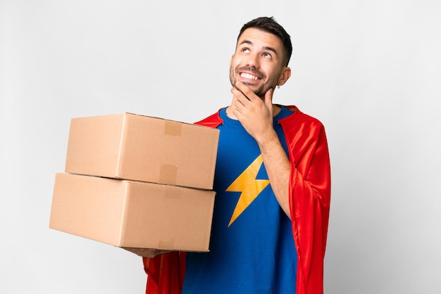 Super Hero delivery caucasian man over isolated white background looking up while smiling