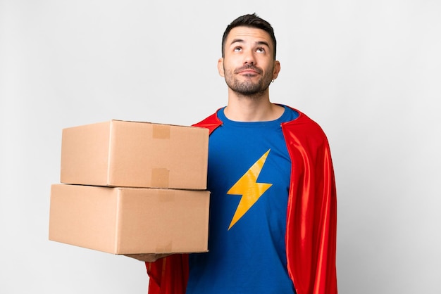 Super Hero delivery caucasian man over isolated white background and looking up