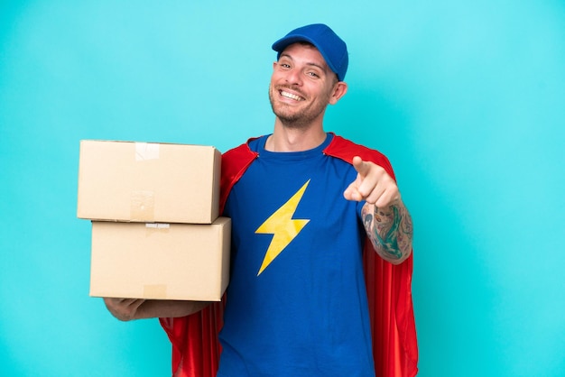 Super Hero delivery man over isolated background pointing front with happy expression