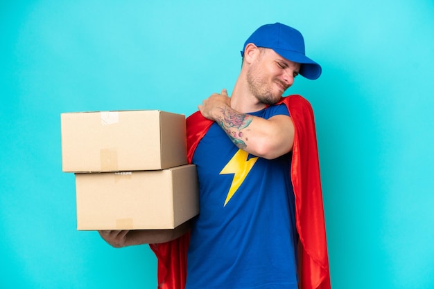 Super Hero delivery man over isolated background suffering from pain in shoulder for having made an effort