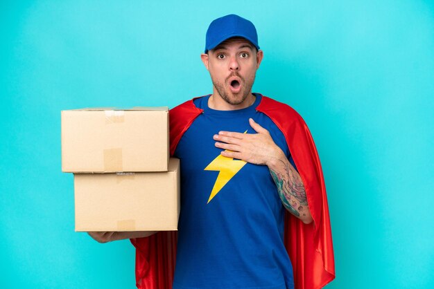 Photo super hero delivery man over isolated background surprised and shocked while looking right