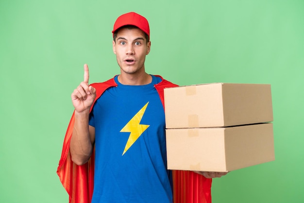 Super Hero delivery man over isolated background thinking an idea pointing the finger up