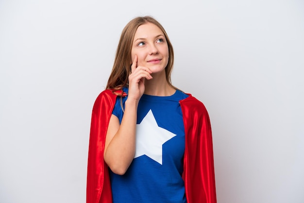 Super Hero Russian woman isolated on white background thinking an idea while looking up