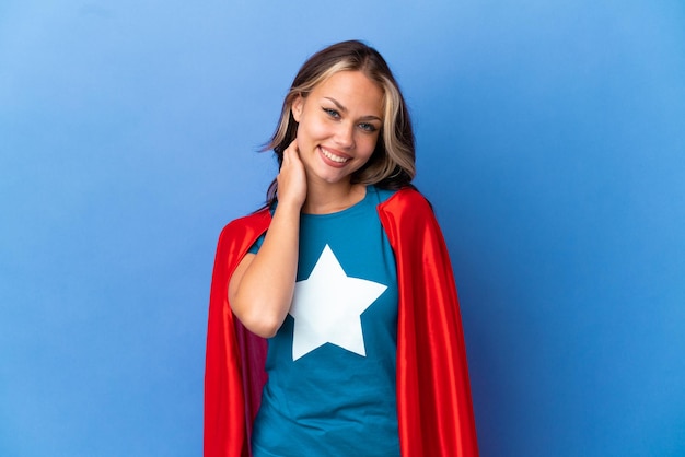 Super Hero Teenager girl isolated on blue background laughing