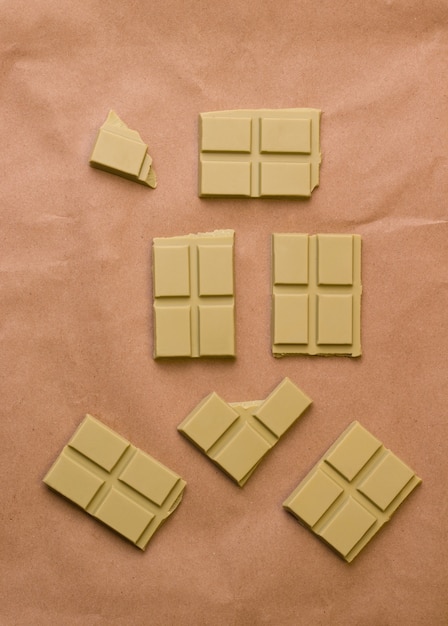 Superfood chocolate with matcha tea on a brown background. View from above