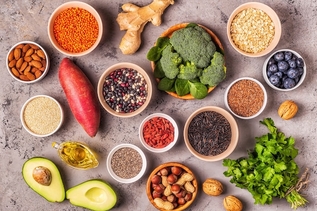 Superfoods on gray concrete background. Healthy food clean eating concept. Top view.