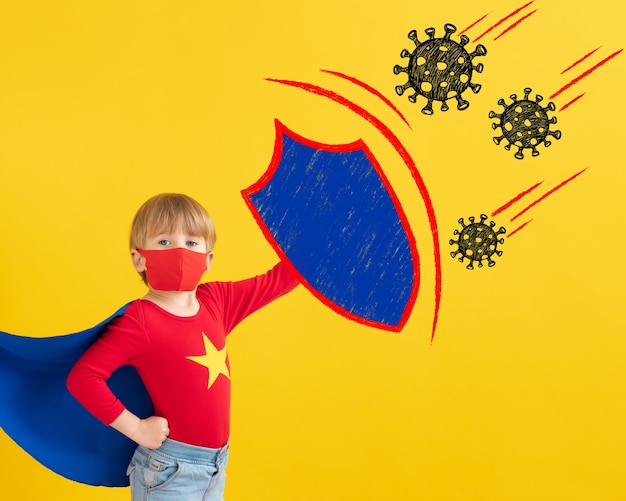 Superhero child wearing protective mask  indoor