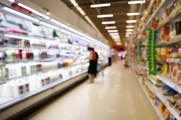 Supermarket Aisle and Shelves with dairy products in refrigerator blur background