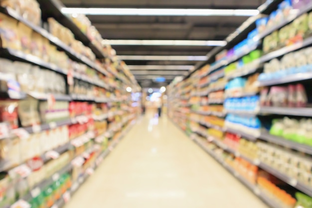 Supermarket aisle with product shelves interior defocused blur