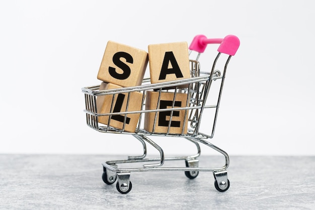 supermarket carts with Percent sign on wooden cubes