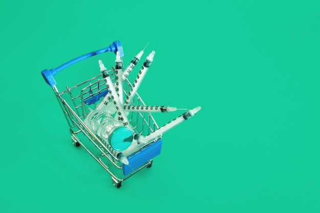 Supermarket trolley with syringes and ampoule isolated