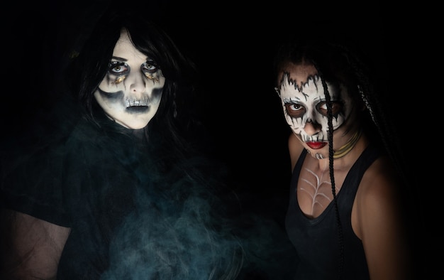 Supernatural entities, portrait of two supernatural entities, artistic makeup, black background, Low Key portrait, selective focus.