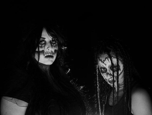 Supernatural entities, portrait of two supernatural entities, artistic makeup, black background, Low Key portrait, selective focus.