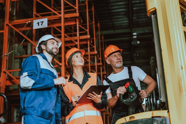 Supervisor and Warehouse Workers Checking Boxes