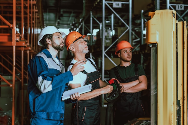 Supervisor and Warehouse Workers Checking Boxes