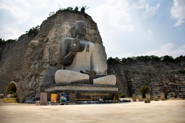 SUPHAN BURI THAILAND OCTOBER 28 Big buddha carving on stone cliff of Wat Khao Tham Thiam for thai people travel visit and respect pray at U Thong city on October 28 2019 in Suphanburi Thailand