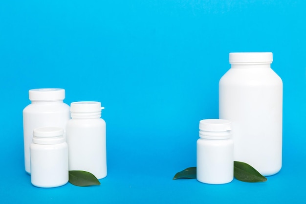 Supplement pills with medicine bottle health care and medical top view Vitamin tablets Top view mockup bottle for pills and vitamins with green leaves natural organic bio supplement copy space