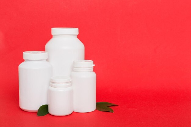 Supplement pills with medicine bottle health care and medical top view Vitamin tablets Top view mockup bottle for pills and vitamins with green leaves natural organic bio supplement copy space