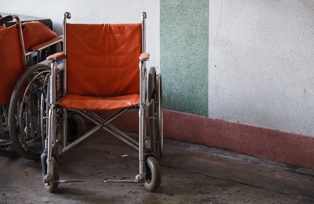 Supporting wheelchairs for elderly, senior citizen, disabled in corner background