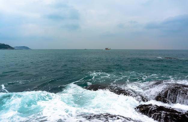 Surf on the rocky shore of the Andaman sea Thailand Phuket